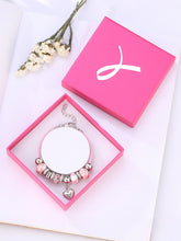 Bracelet perlé rose de conscience de cancer du sein des femmes